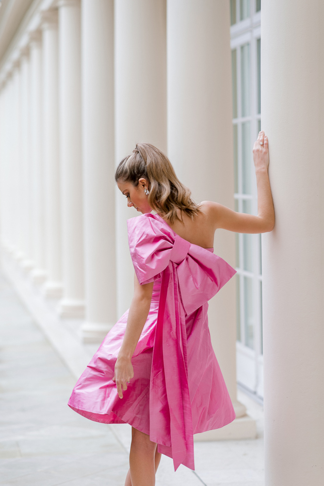 Beautiful girl wearing pink dress and posing for photos in London hotel