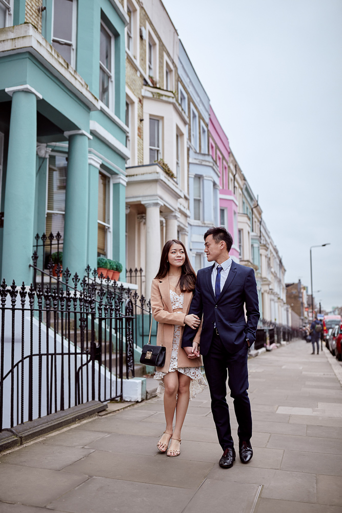 Couple walking hand in hand in Notting Hill during engagement photoshoot in London