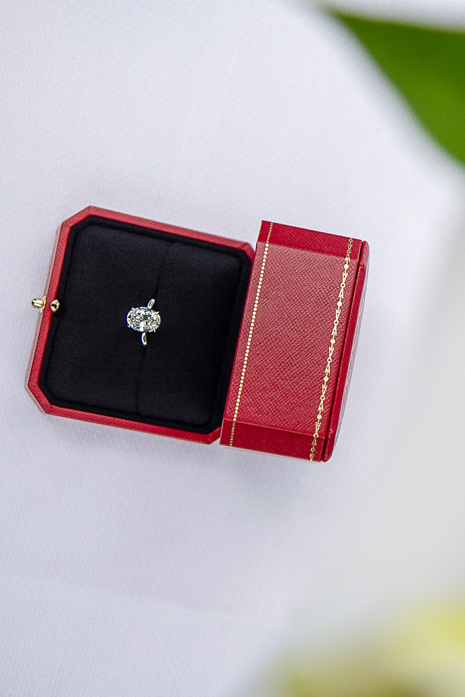 Diamond engagement ring in a red Cartier box