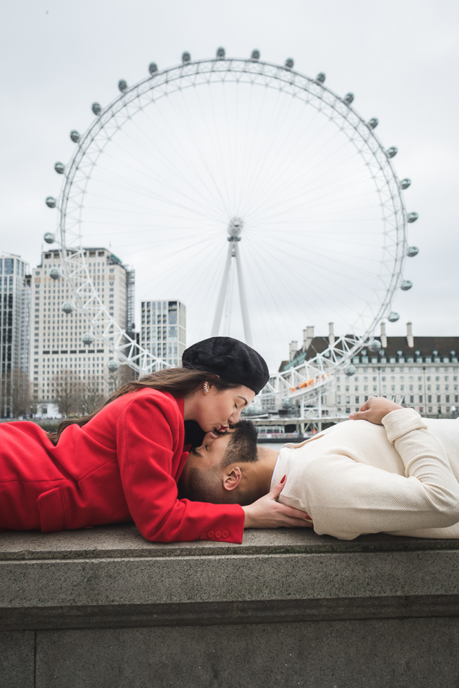 Sweet couple kissing in front of London Eye