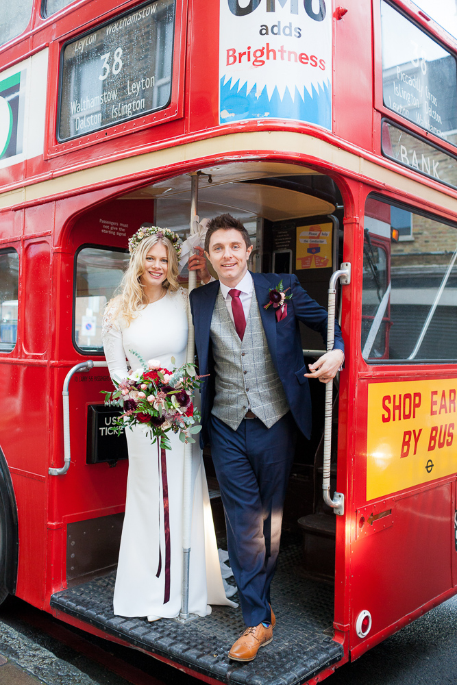 Bride and groom smiling for pictures on their London elopement