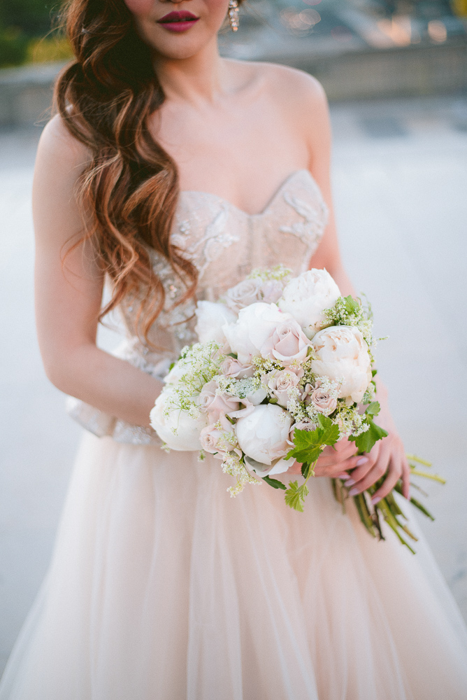 Bride holding white bouquet of flowers