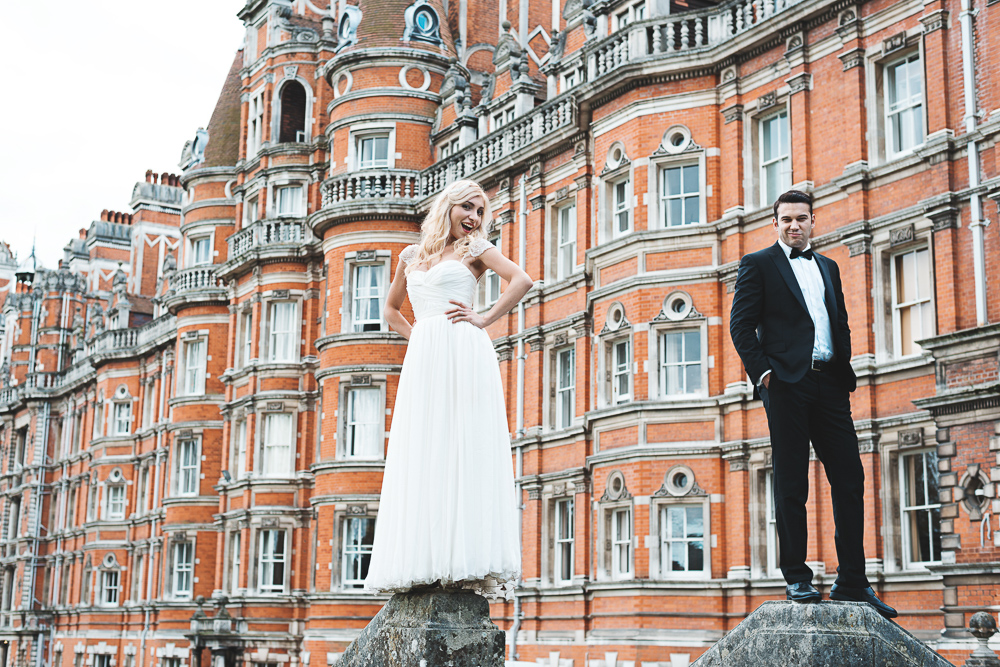 Happy couple posing in front of Royal Holloway in London