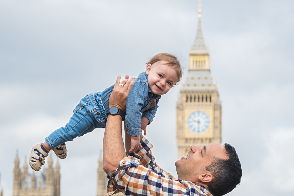 London family photographer capturing a father throwing up baby in front of the Big Ben