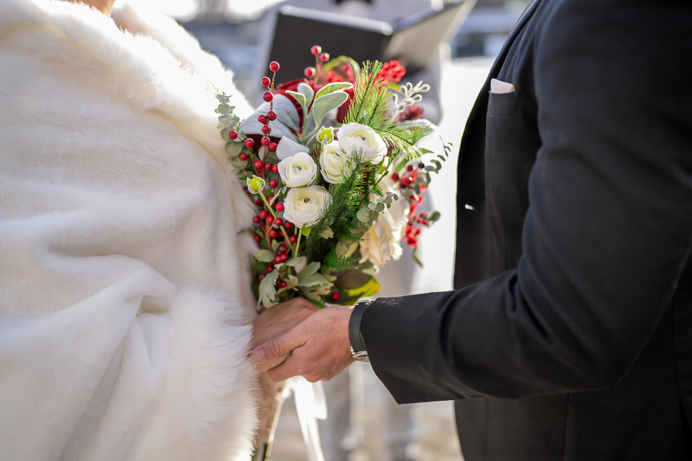 Close up shot of holding hands during an elopement