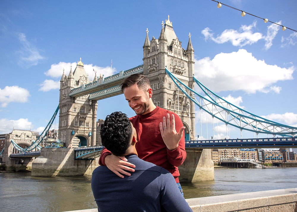 Couple celebrating their engagement moment close by the Tower Bridge