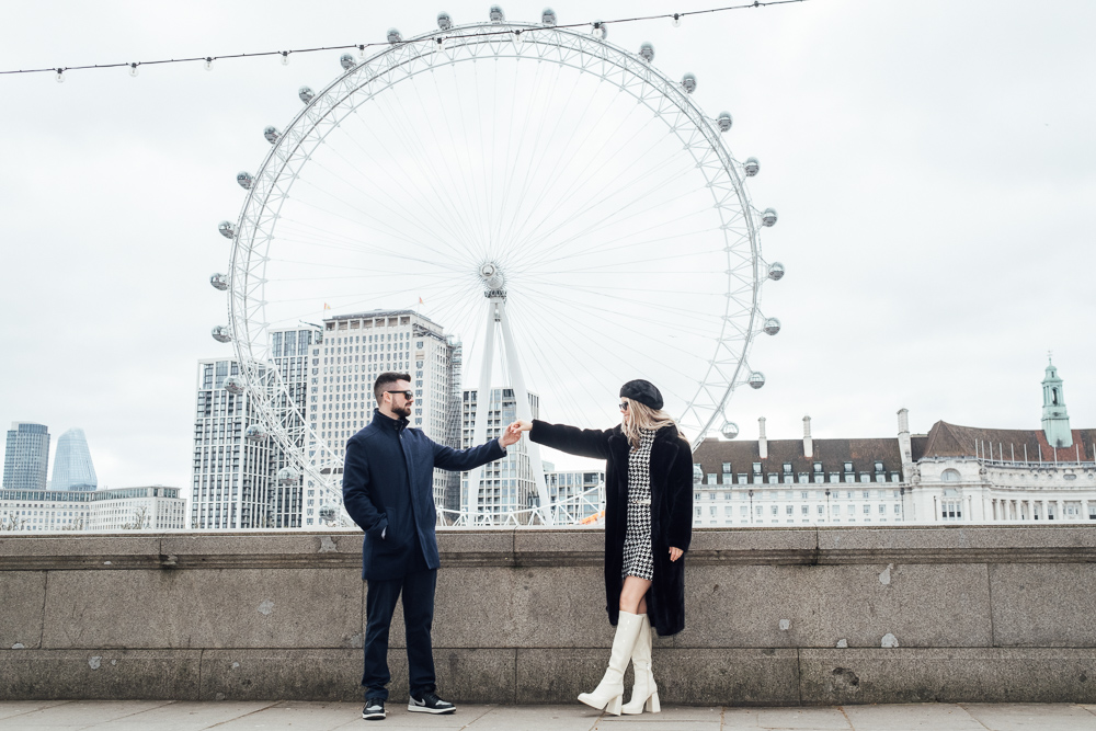 Couple posing for photos in winter by the London Eye