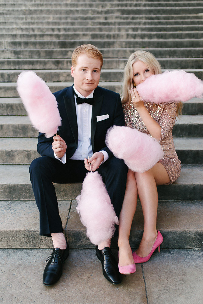 stylish couple posing for engagement photos with cotton candy in London