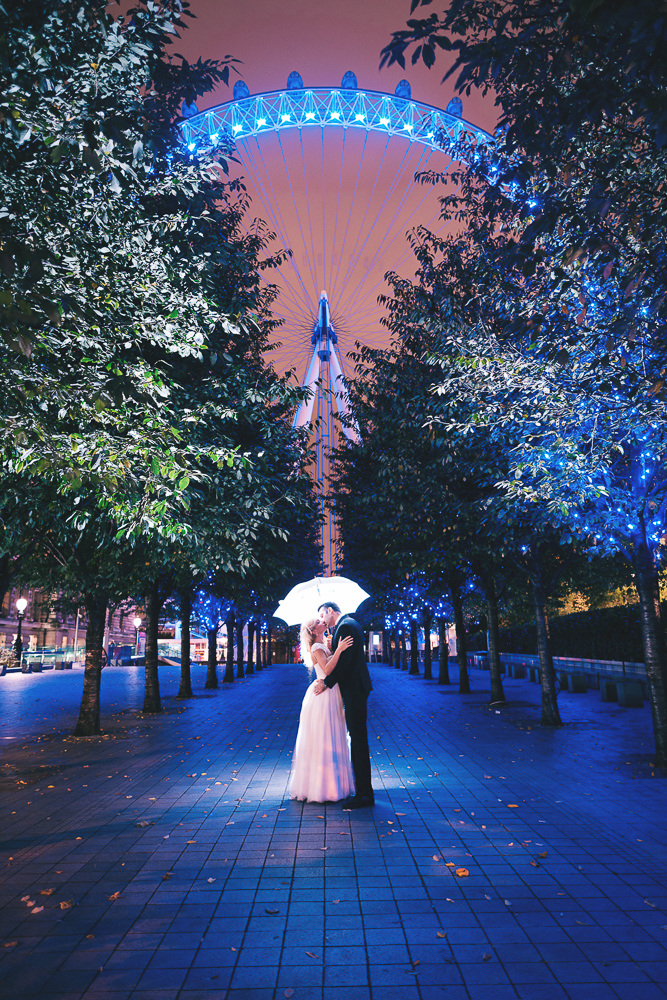Bride and groom posing for wedding photos at night around London Eye