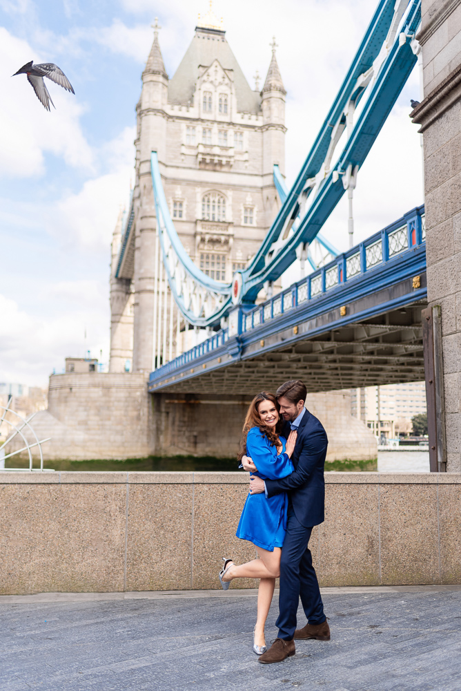 Couple dancing next to London bridge while taking engagement photos with The Now Time photographers