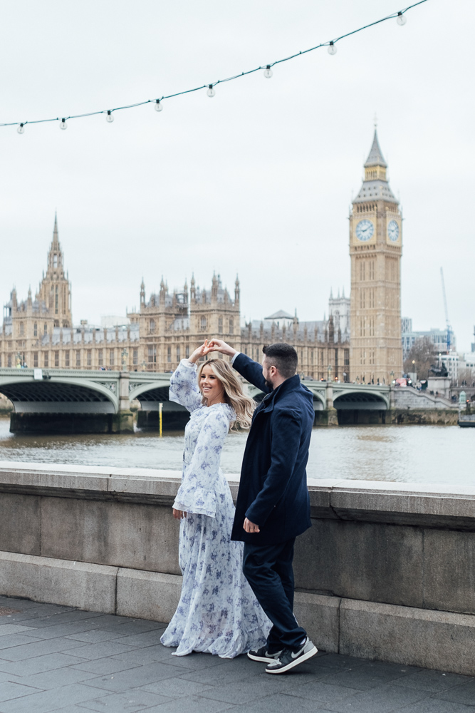 Couple dancing next to the Thames river