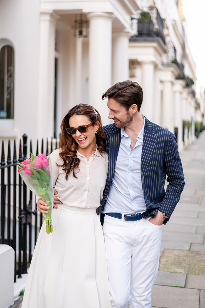 Couple walking hugging in the beautiful streets of Eaton Square