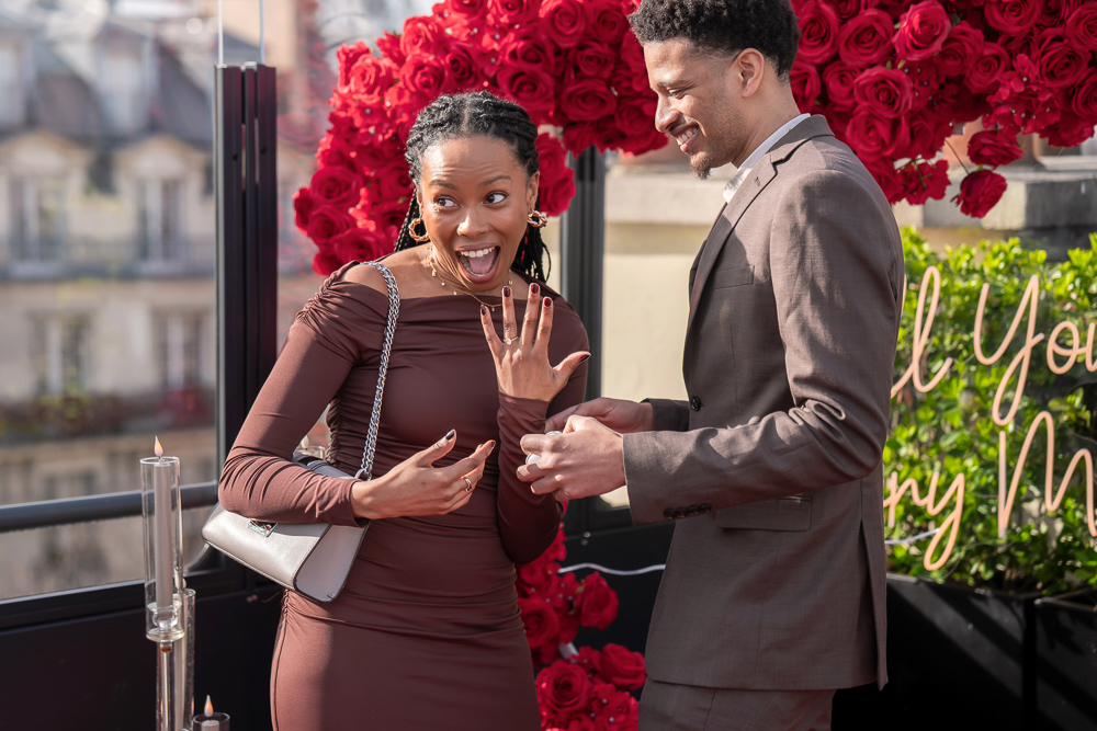 Happy woman showing engagement ring after surprise marriage proposal