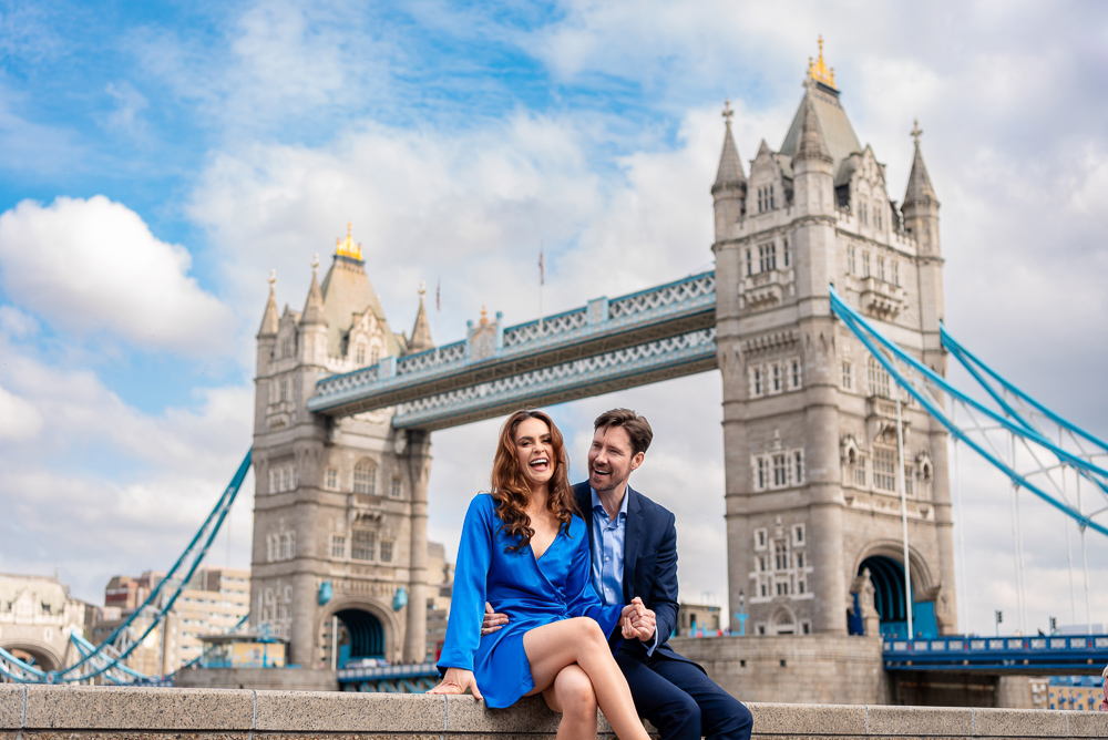 Young couple having fun during a pofessional photo session at Tower Bridge