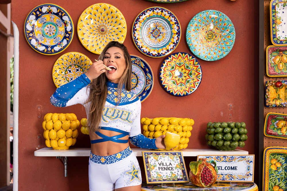 Beautiful athletic girl eating ice cream out of lemon in Positano on the Amalfi coast