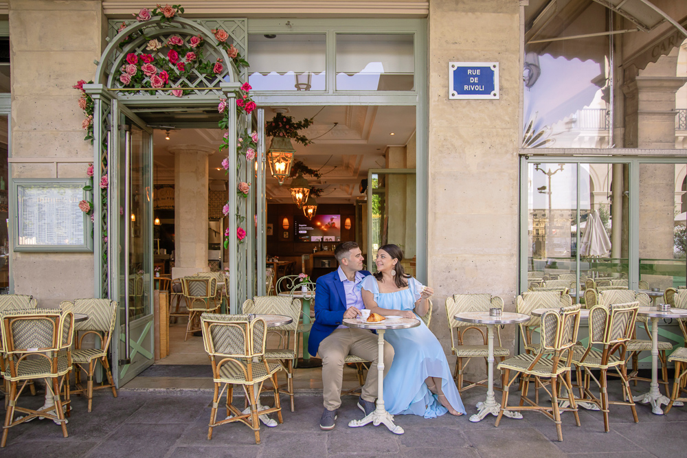 Newly engaged couple posing for engagement photographer in a café