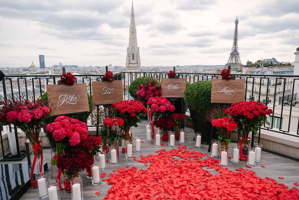Romantic setup with red roses and personalized items put together by a proposal planner