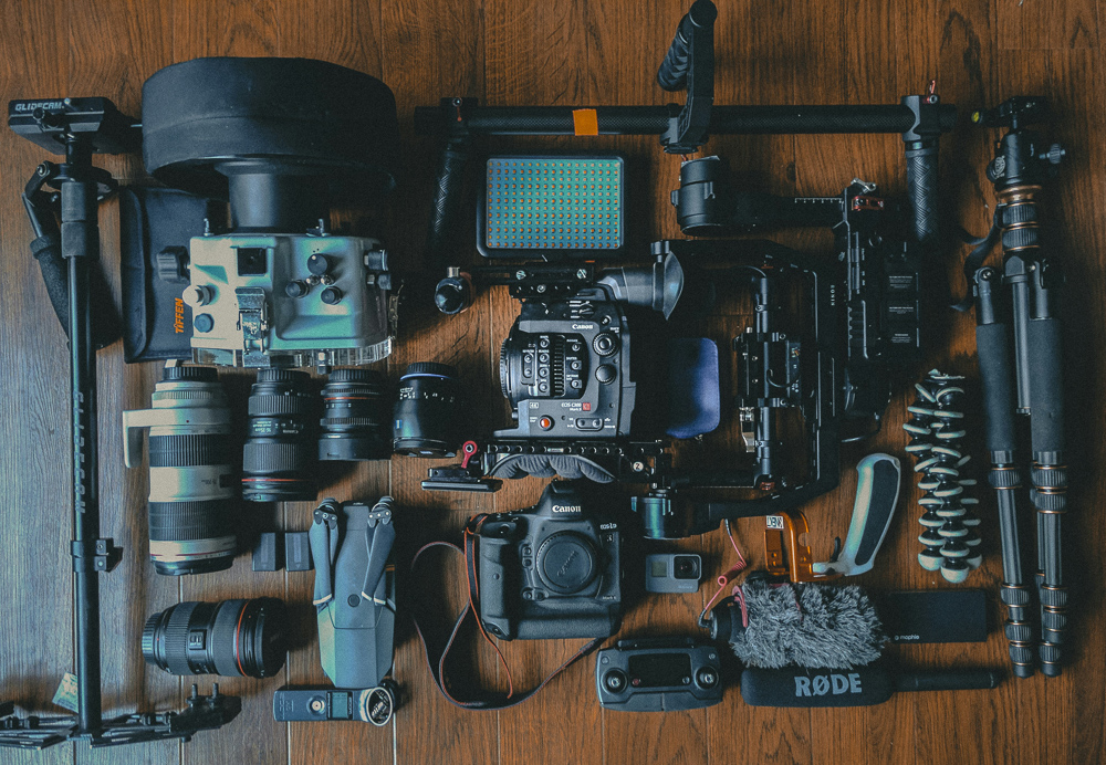 Why photography is expensive - Picture of a bunch of photography gear layed out on a table