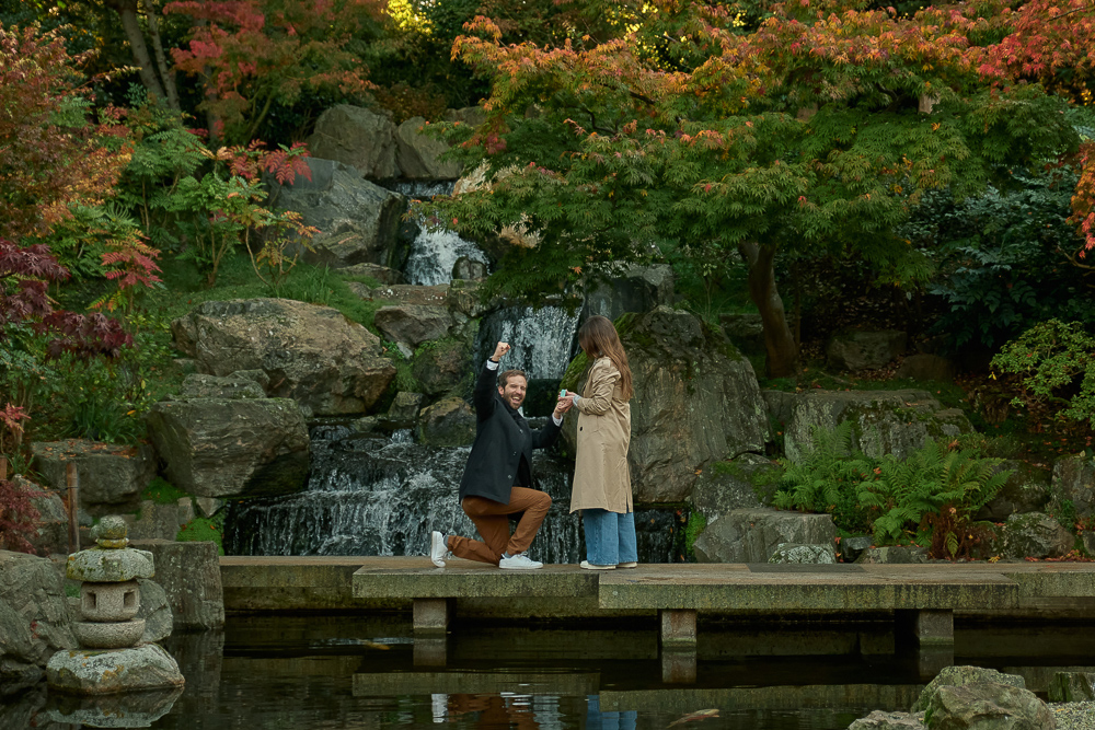 Young man celebrating his engagement to his girlfriend in Kyoto Gardens in London