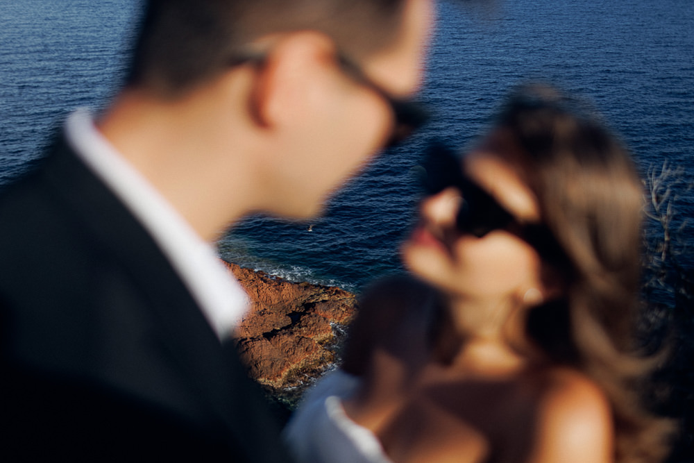 Bride and groom posing for elopement photo shoot on the beach in Cannes