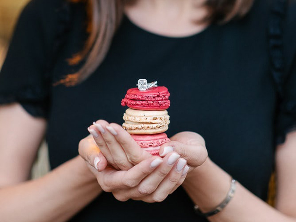 Engagement ring on top of macarons