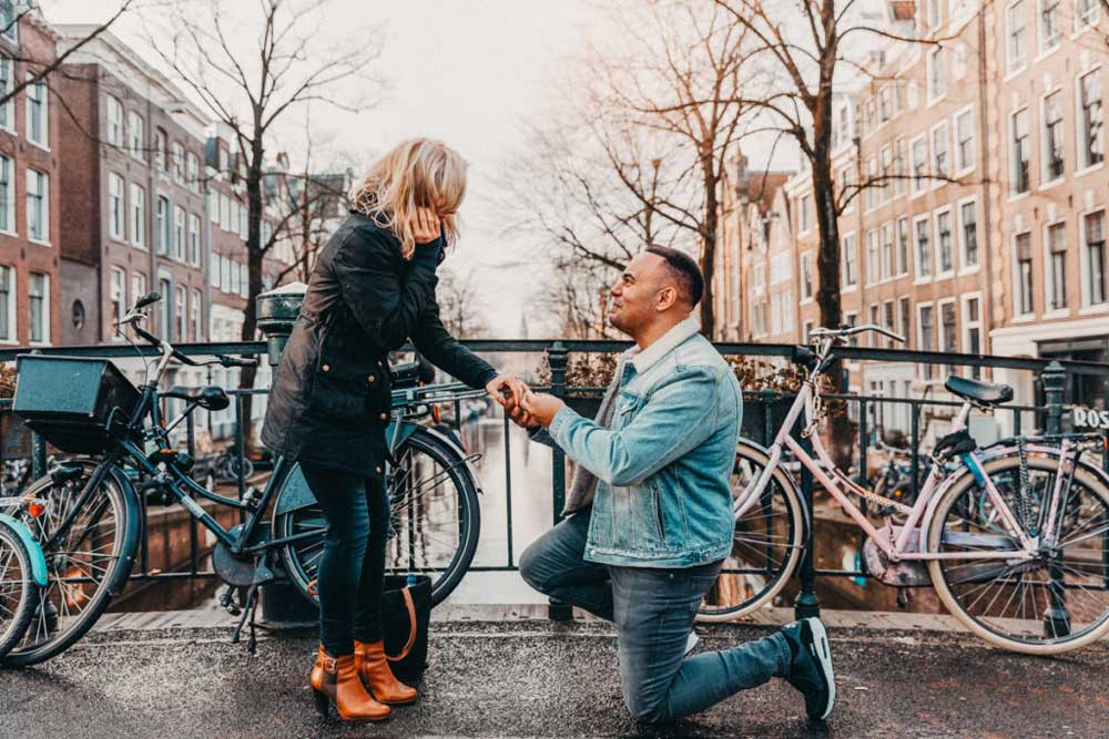 A man kneeling for a marriage proposal in Amsterdam